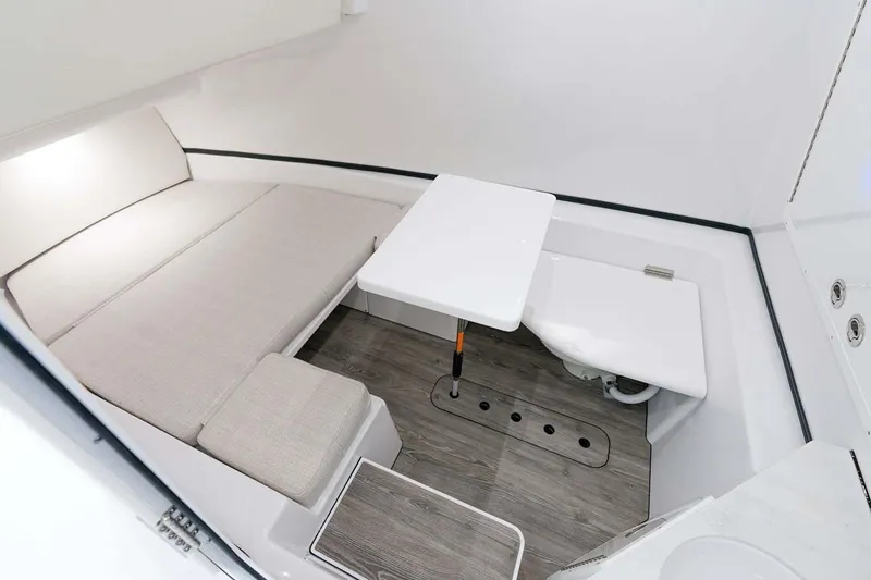 Slide: The Image of Manufacturer Provided Image: Interior cabin of 2022 Sportsman Open 352 Center Console boat with seating and table. - 20
