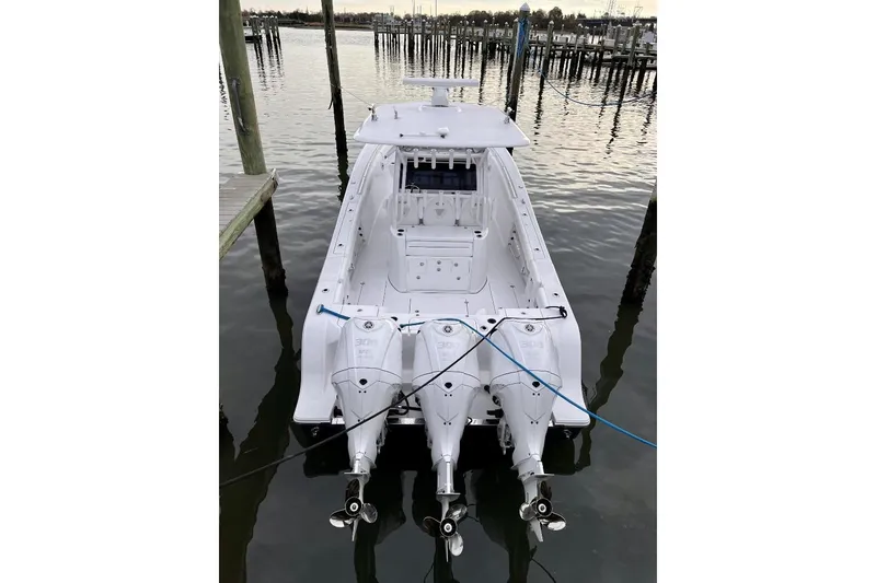Slide: The Image of 2022 Sportsman Open 352 Center Console boat docked with triple engines. - 3