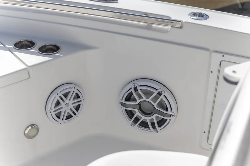 Slide: The Image of 2024 Crevalle 26 HCO boat interior with JL Audio speakers and cup holders. - 10