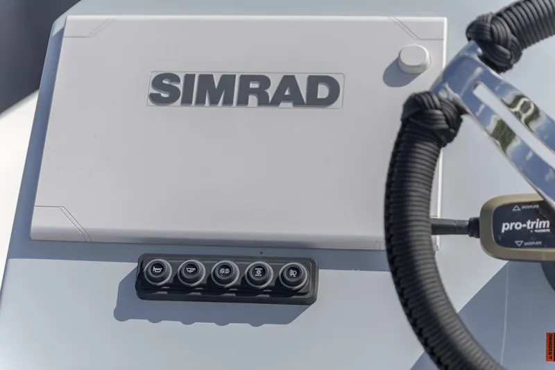 Slide: The Image of 2024 Crevalle 26 HCO boat dashboard featuring Simrad display and controls. - 15