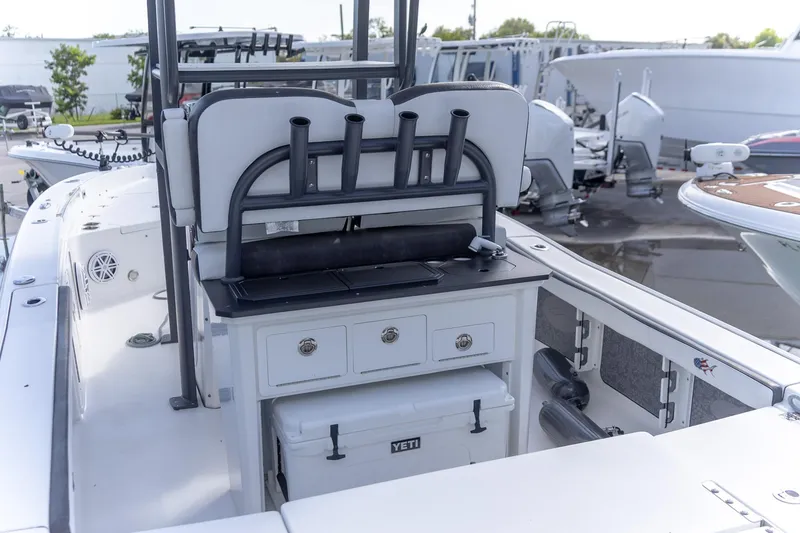 Slide: The Image of 2024 Crevalle 26 HCO boat interior with rod holders and storage compartments. - 16