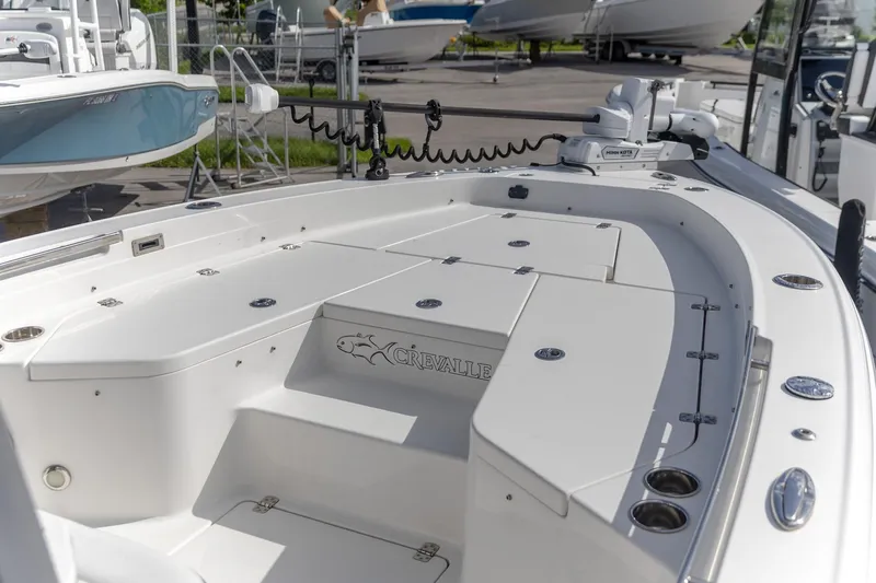 Slide: The Image of 2024 Crevalle 26 HCO boat deck with storage compartments and fishing rod holders. - 3