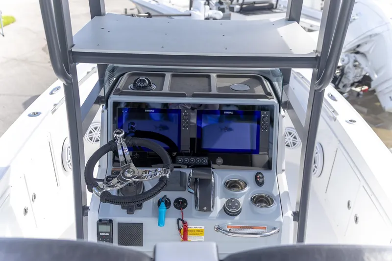 Slide: The Image of 2024 Crevalle 26 HCO boat dashboard with dual Simrad displays and modern controls. - 5