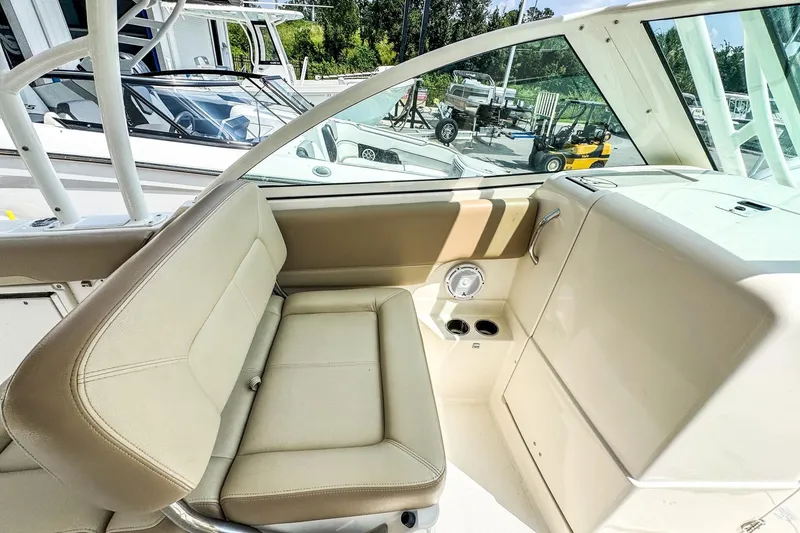 Slide: The Image of 2018 Sailfish 275 DC boat interior with beige seating and cup holders. - 14