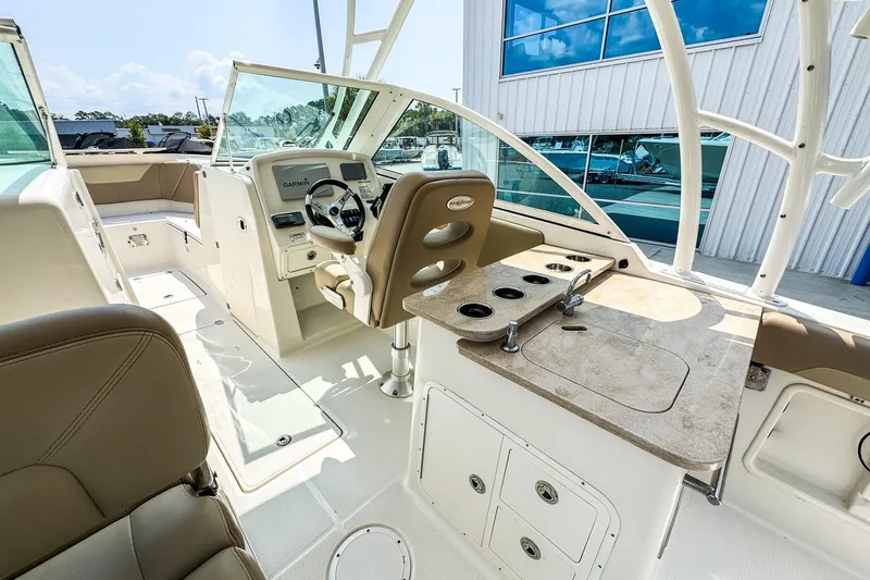 Slide: The Image of 2018 Sailfish 275 DC boat interior with helm, seating, and fishing station. - 8