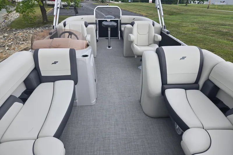 Slide: The Image of 2023 Starcraft EX 22 R pontoon boat interior with plush seating and modern design. - 10