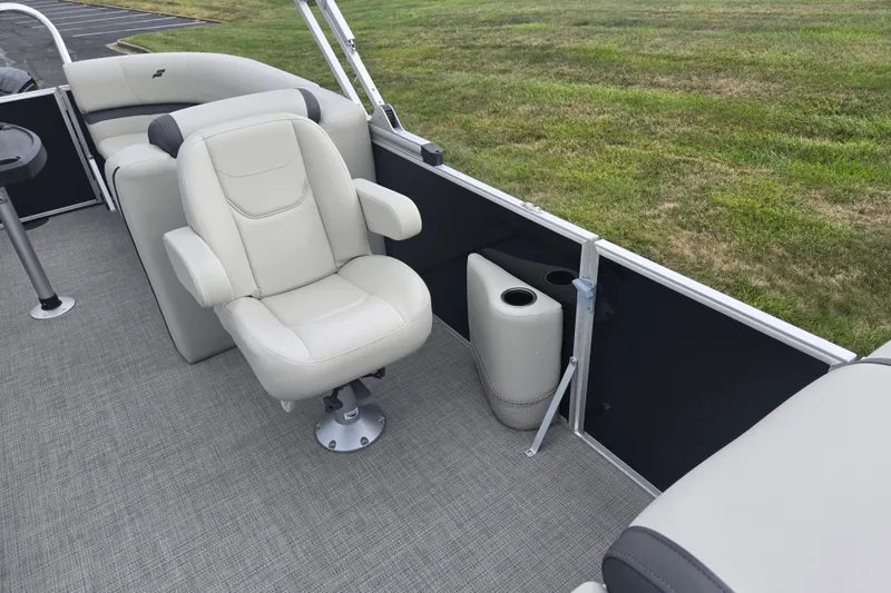 Slide: The Image of 2023 Starcraft EX 22 R boat interior with beige seating and gray flooring. - 11