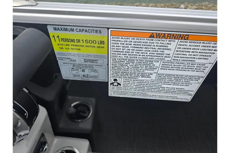 Slide: The Image of 2023 Starcraft EX 22 R boat capacity and safety warning labels, highlighting maximum load and safety instructions. - 13