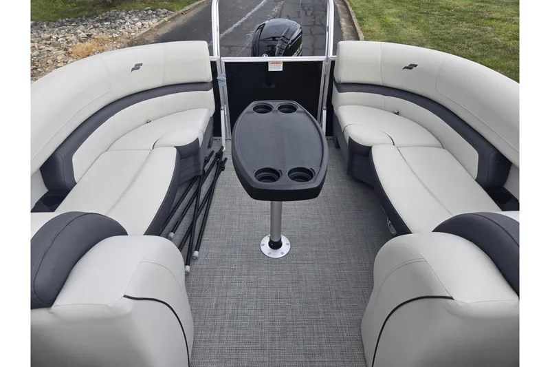 Slide: The Image of 2023 Starcraft EX 22 R pontoon boat interior with plush seating and central table. - 14