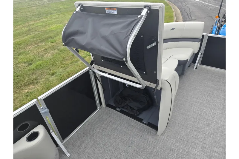 Slide: The Image of 2023 Starcraft EX 22 R pontoon boat interior with storage compartment open. - 18
