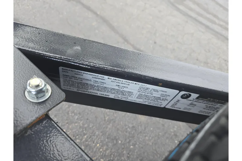 Slide: The Image of Close-up of a 2023 Starcraft EX 22 R trailer label and bolt detail. - 22