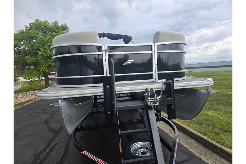 Slide: The Image of 2023 Starcraft EX 22 R pontoon boat on trailer, parked outdoors. - 6