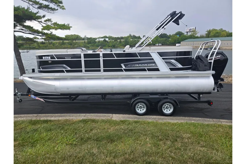 Slide: The Image of 2023 Starcraft EX 22 R pontoon boat on trailer by a lakeside. - 8