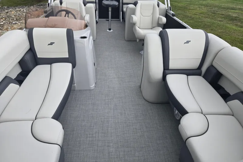 Slide: The Image of 2023 Starcraft EX 22 R pontoon boat interior with plush seating and modern design. - 9