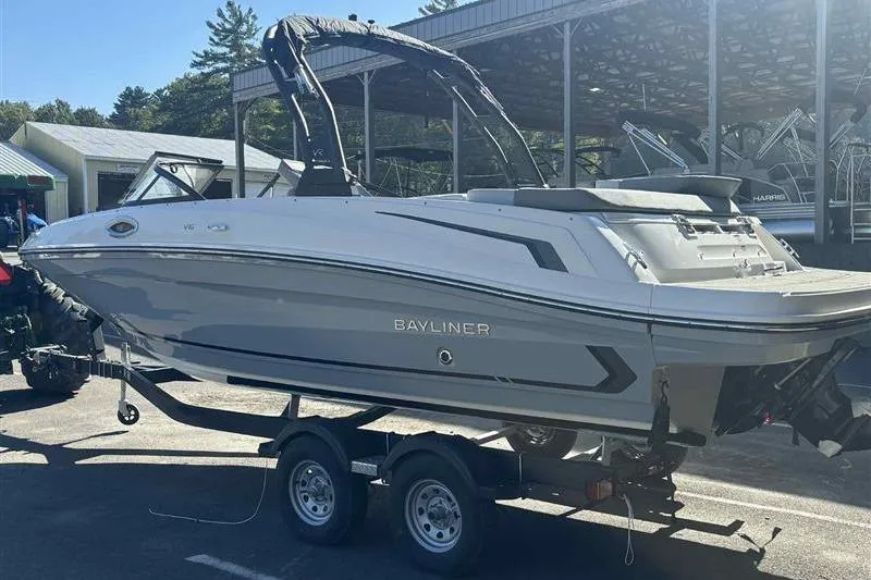 Slide: The Image of 2026 Bayliner VR6 Bowrider I/O on trailer, parked outdoors at a marina. - 1