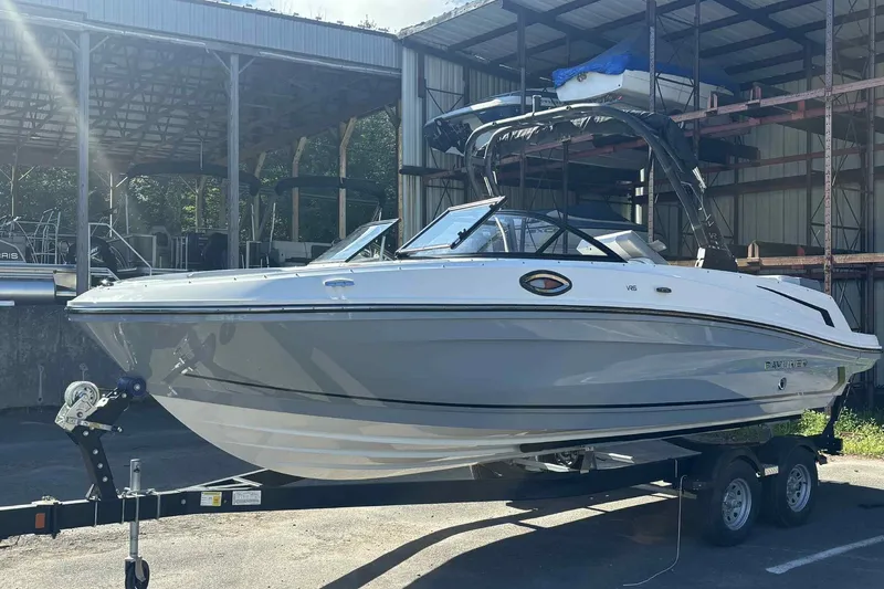 Slide: The Image of 2026 Bayliner VR6 Bowrider I/O boat on trailer in storage facility. - 9
