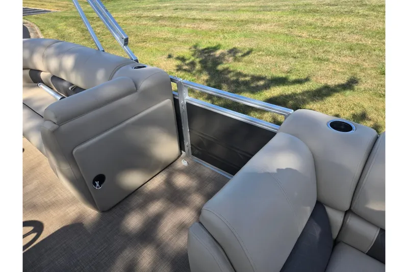 Slide: The Image of 2024 Sun Tracker Party Barge 20 DLX interior with plush seating and cup holders. - 12