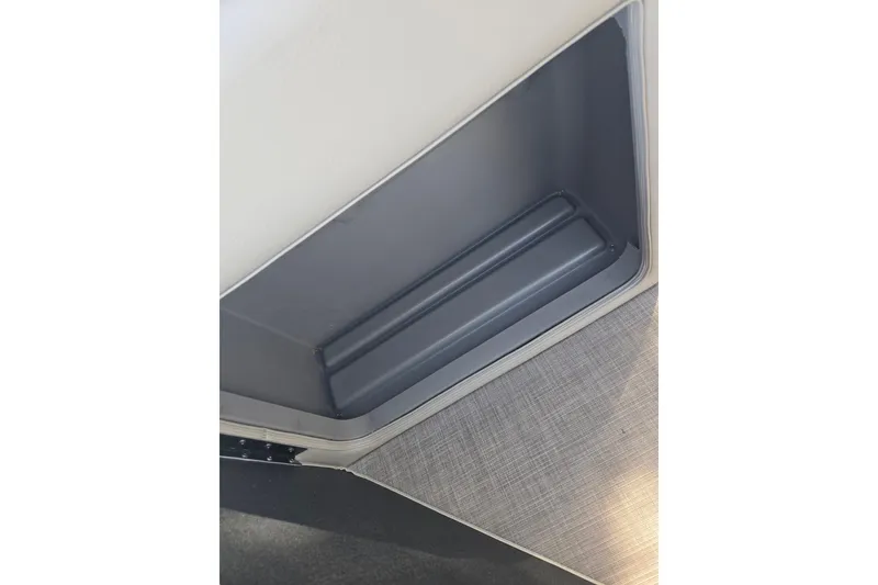 Slide: The Image of 2024 Sun Tracker Party Barge 20 DLX storage compartment with sleek interior design. - 13