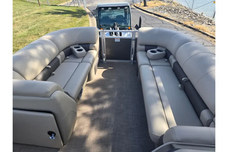 Slide: The Image of 2024 Sun Tracker Party Barge 20 DLX with spacious seating and cup holders on a sunny day. - 23