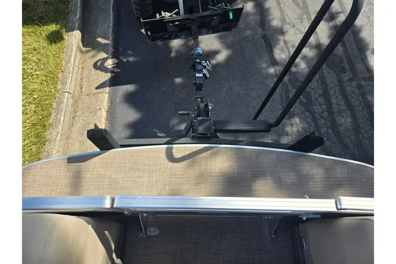 Slide: The Image of 2024 Sun Tracker Party Barge 20 DLX pontoon boat hitched to a trailer. - 24