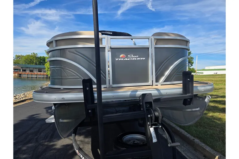 Slide: The Image of 2024 Sun Tracker Party Barge 20 DLX pontoon boat on trailer by the water. - 6