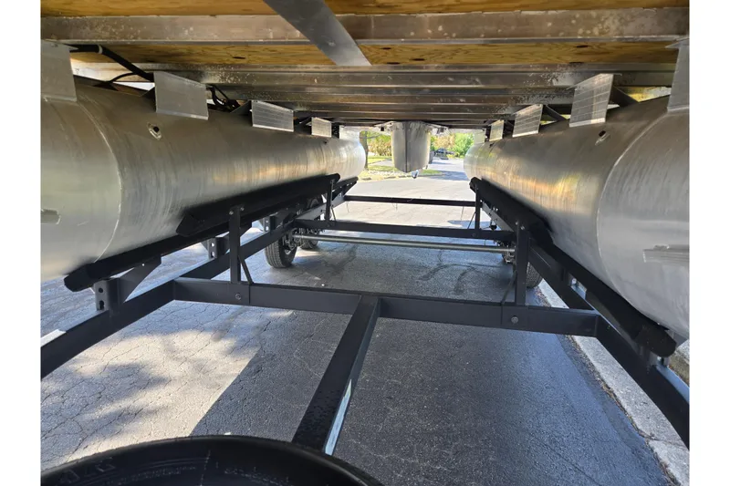 Slide: The Image of Underneath view of 2024 Sun Tracker Party Barge 20 DLX pontoon boat on trailer. - 7