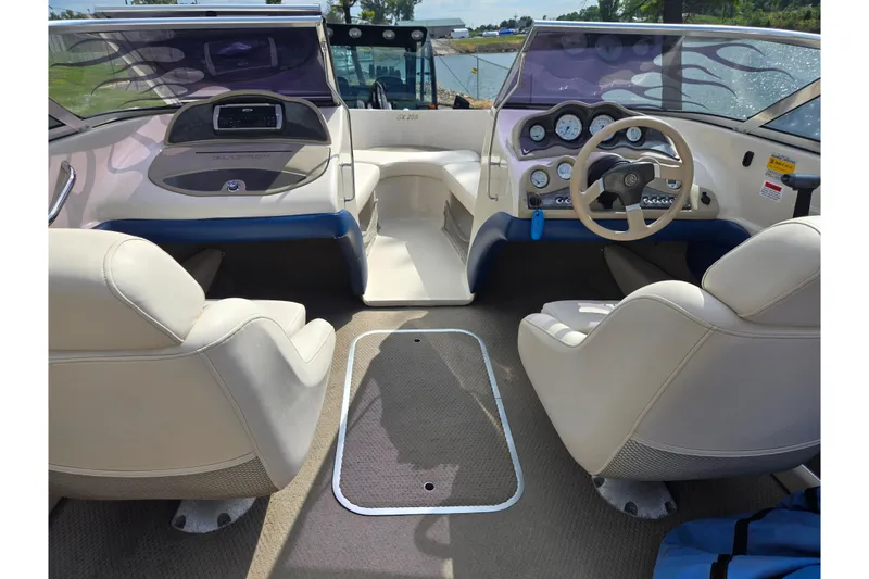 Slide: The Image of Interior of a 2001 Glastron GX 205 boat with beige seating and dashboard. - 11