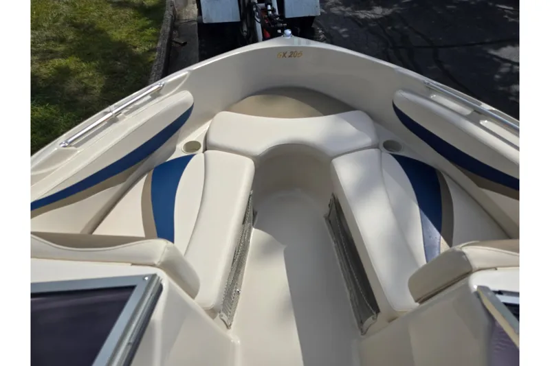 Slide: The Image of 2001 Glastron GX 205 boat interior with white and blue seating, showcasing spacious design. - 15