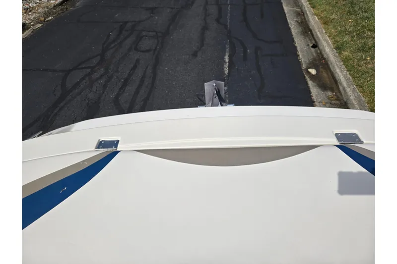 Slide: The Image of 2001 Glastron GX 205 boat on a trailer, viewed from above on a paved road. - 22