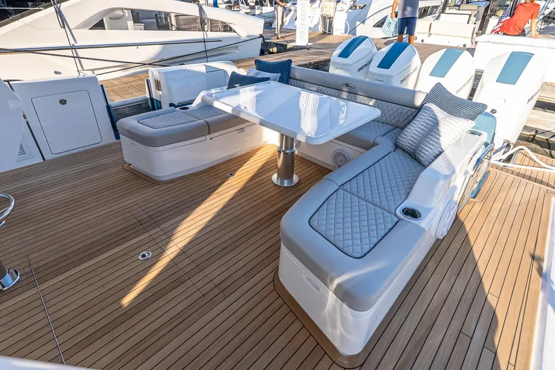 Slide: The Image of Luxurious deck of 2026 Valhalla V-55 Sport Yacht with elegant seating and table. - 13