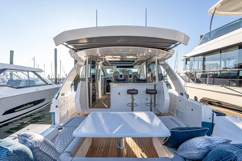 Slide: The Image of 2026 Valhalla V-55 Sport Yacht, luxurious deck view with seating and bar stools. - 14