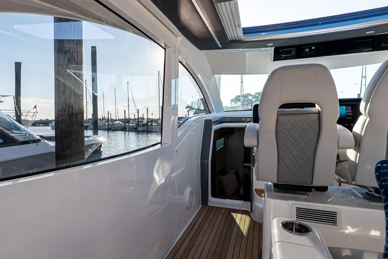 Slide: The Image of Interior of 2026 Valhalla V-55 Sport Yacht with luxurious seating and marina view. - 23
