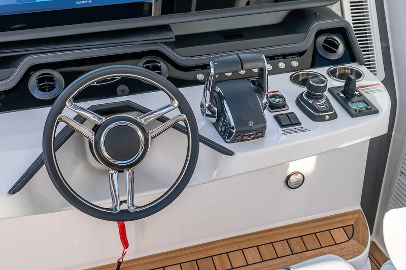 Slide: The Image of 2026 Valhalla V-55 Sport Yacht helm with steering wheel and controls. - 30