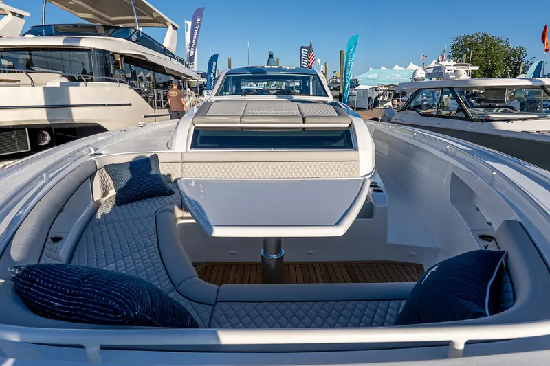 Slide: The Image of 2026 Valhalla Boatworks V-55 Sport Yacht with luxurious seating and sleek design at a boat show. - 39