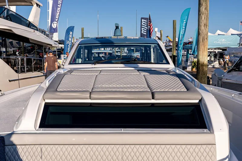 Slide: The Image of 2026 Valhalla V-55 Sport Yacht at a boat show, featuring sleek design and luxury seating. - 40