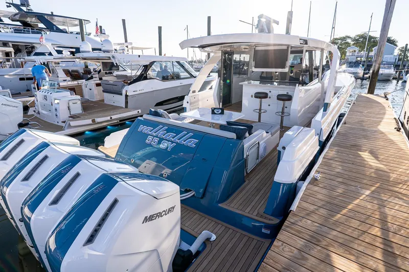 Slide: The Image of 2026 Valhalla V-55 Sport Yacht docked, showcasing sleek design and powerful Mercury engines. - 8