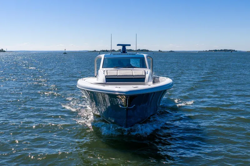 Slide: The Image of 2026 Valhalla Boatworks V-55 Sport Yacht cruising on open water under clear skies. - 2
