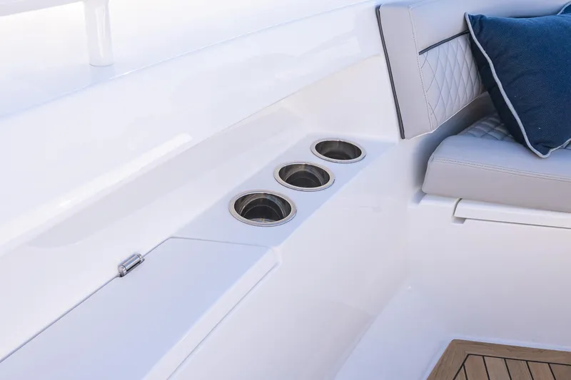 Slide: The Image of 2026 Valhalla V-55 Sport Yacht interior with cup holders and cushioned seating. - 44