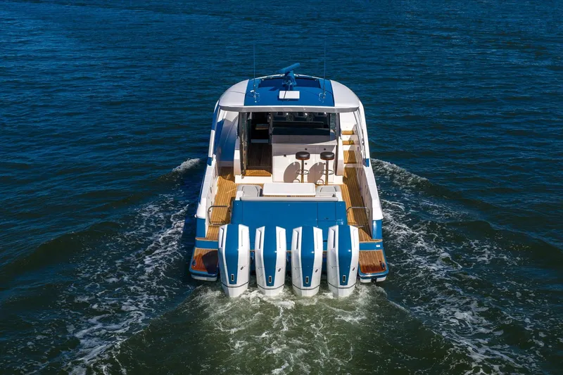 Slide: The Image of 2026 Valhalla Boatworks V-55 Sport Yacht cruising on open water, rear view. - 7