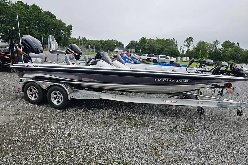 Slide: The Image of 2018 Phoenix 921 ProXP bass boat on a trailer in a parking lot. - 0