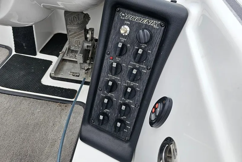 Slide: The Image of Control panel of a 2018 Phoenix 921 ProXP boat with various switches and buttons. - 11