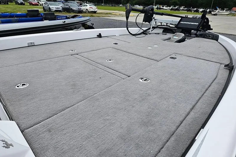 Slide: The Image of 2018 Phoenix 921 ProXP boat deck with gray carpet and storage compartments. - 12