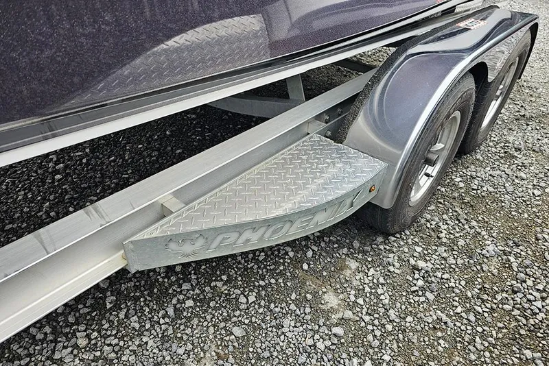 Slide: The Image of 2018 Phoenix 921 ProXP trailer with diamond plate step on gravel surface. - 15