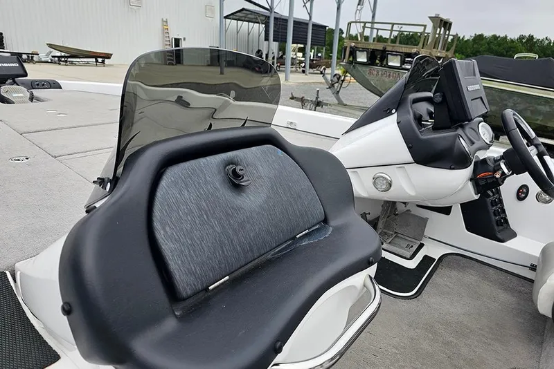 Slide: The Image of 2018 Phoenix 921 ProXP boat interior with steering console and seating area. - 18