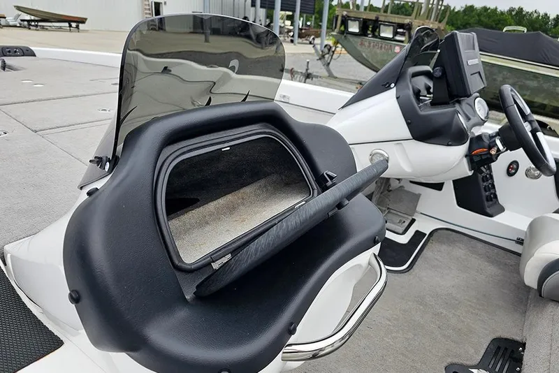 Slide: The Image of 2018 Phoenix 921 ProXP boat interior with open storage compartment and steering console. - 19