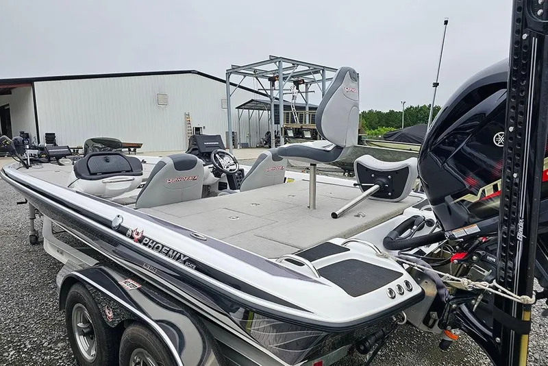Slide: The Image of 2018 Phoenix 921 ProXP boat with Yamaha engine, parked outdoors near a warehouse. - 5