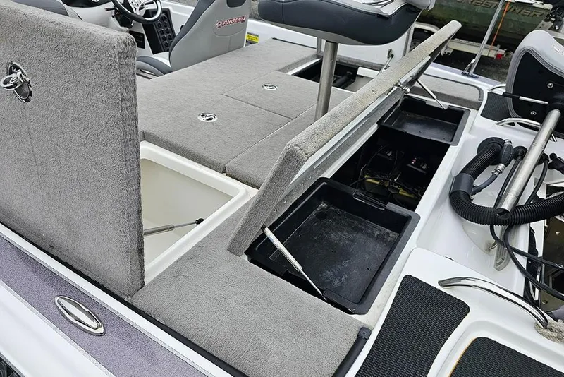 Slide: The Image of 2018 Phoenix 921 ProXP boat interior with open storage compartments and seating. - 7
