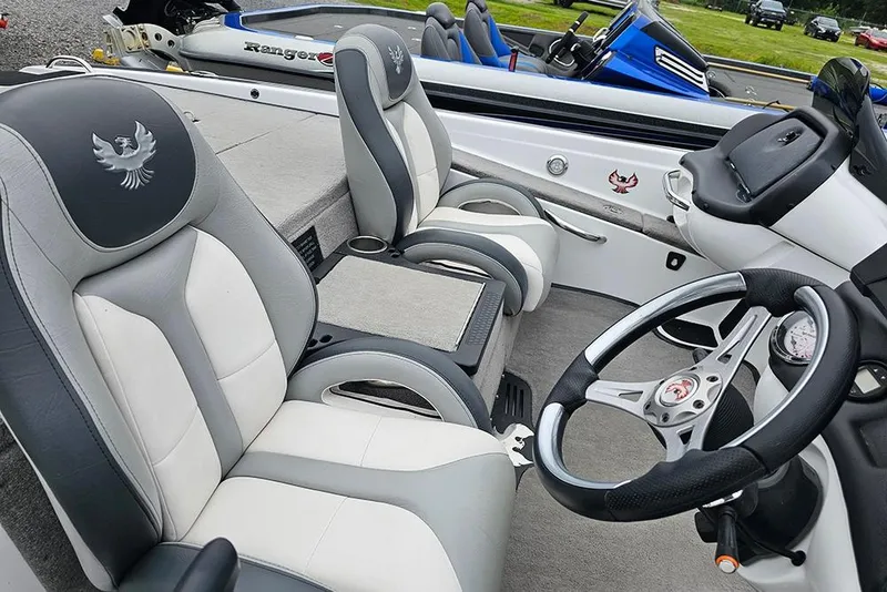 Slide: The Image of 2018 Phoenix 921 ProXP boat interior with gray and white seats and steering wheel. - 9