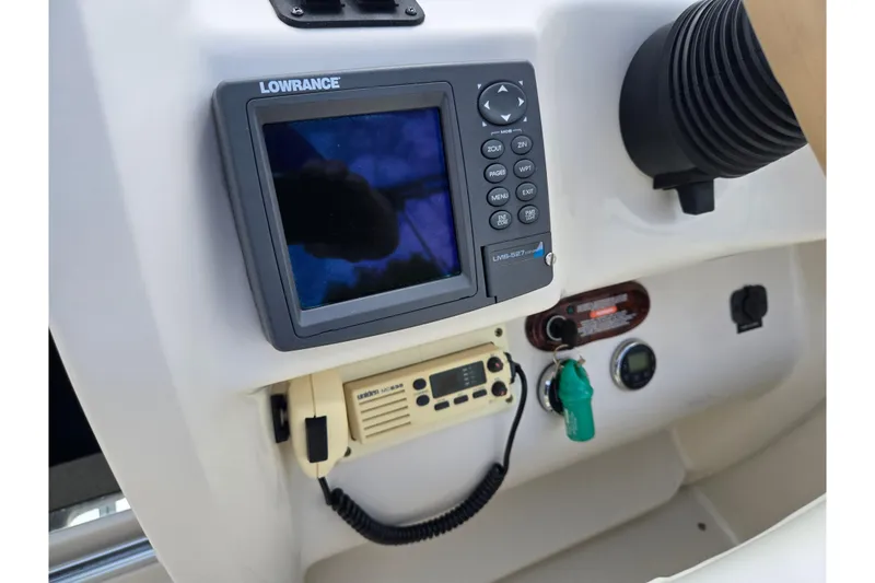 Slide: The Image of Control panel of 2002 Sea Ray 225 Weekender with Lowrance navigation system and radio. - 14
