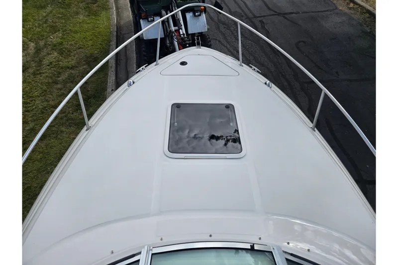 Slide: The Image of 2002 Sea Ray 225 Weekender boat deck with hatch, parked on a trailer. - 18